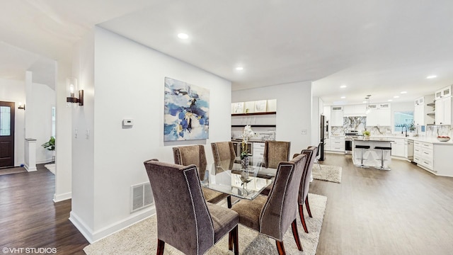 dining area with hardwood / wood-style flooring