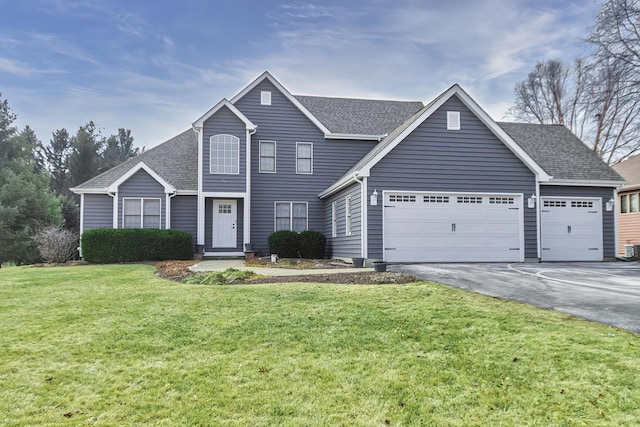 view of front of property featuring a garage and a front lawn