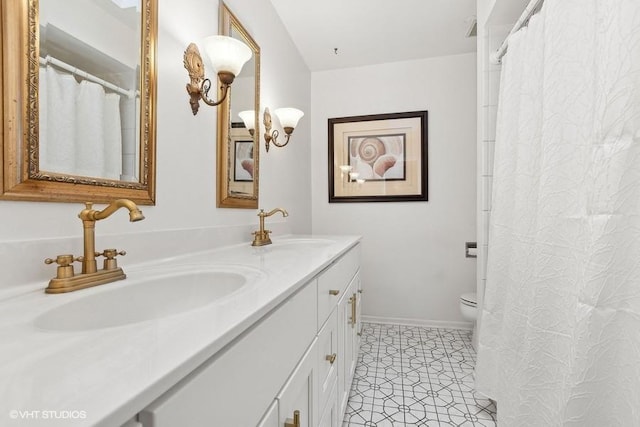 bathroom featuring vanity, tile patterned floors, and toilet