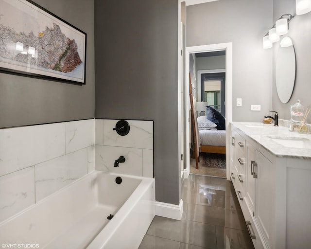 bathroom with tile patterned floors, vanity, and a tub