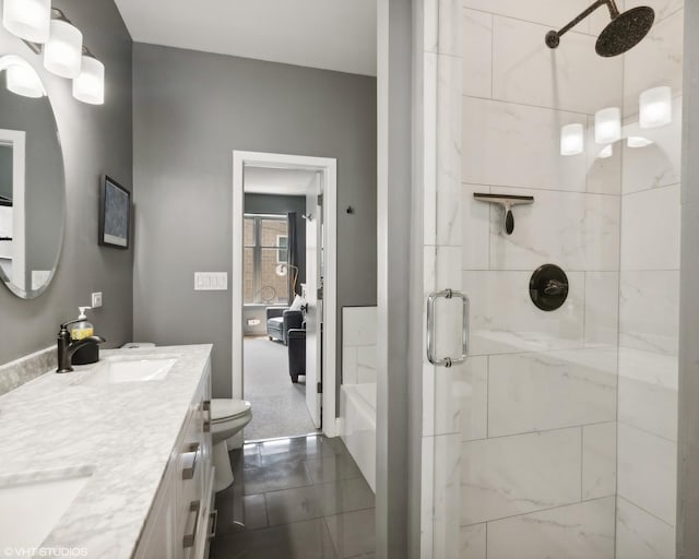 bathroom featuring vanity, toilet, and an enclosed shower