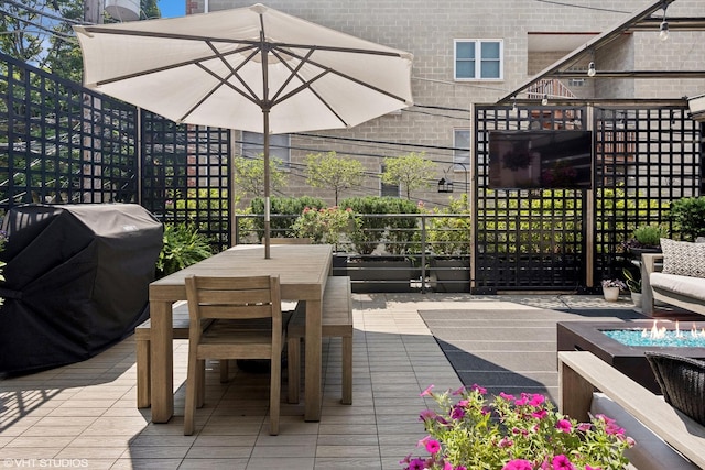 wooden terrace featuring a grill