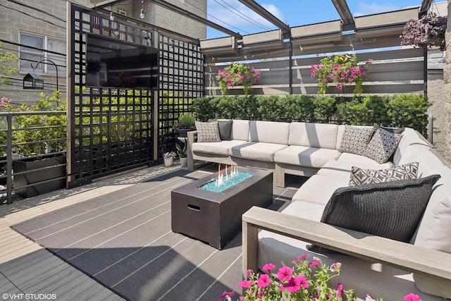 view of patio / terrace featuring an outdoor living space with a fire pit and a pergola