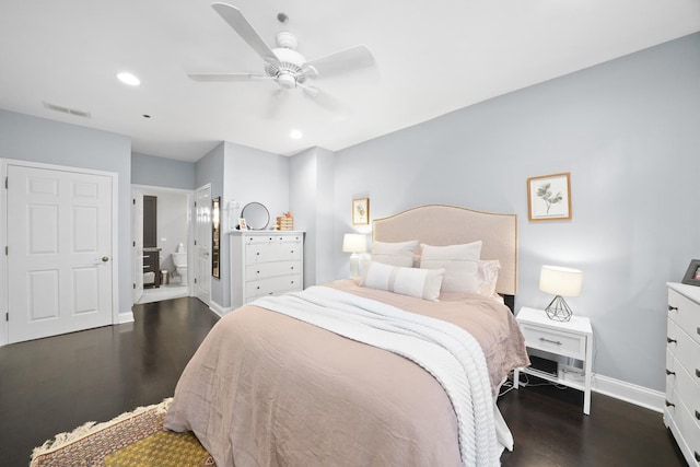 bedroom with dark wood-type flooring, connected bathroom, and ceiling fan