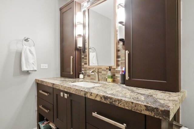 bathroom with tasteful backsplash and vanity