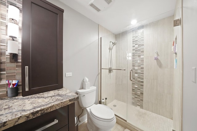 bathroom featuring vanity, toilet, and walk in shower