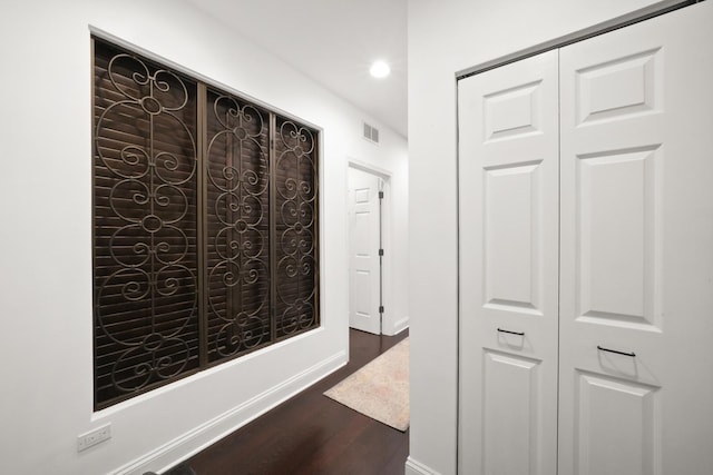 corridor featuring dark wood-type flooring