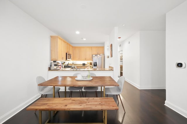 dining space featuring dark hardwood / wood-style floors and sink