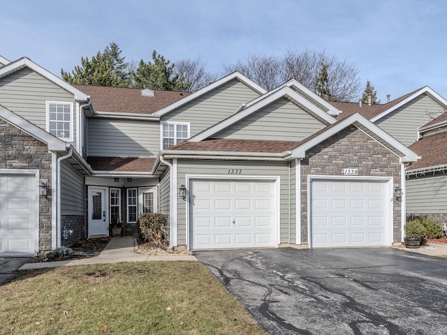 view of front of home featuring a garage and a front lawn