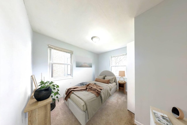 carpeted bedroom featuring multiple windows