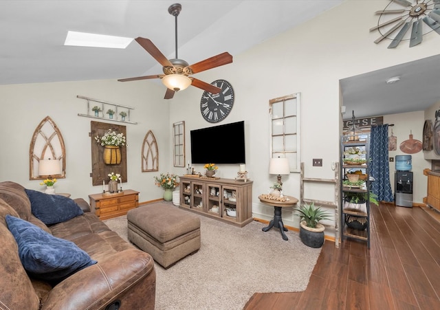 living area featuring dark wood-type flooring, baseboards, ceiling fan, and lofted ceiling with skylight