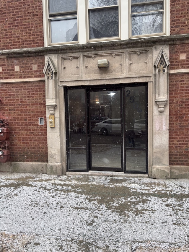 view of snow covered property entrance