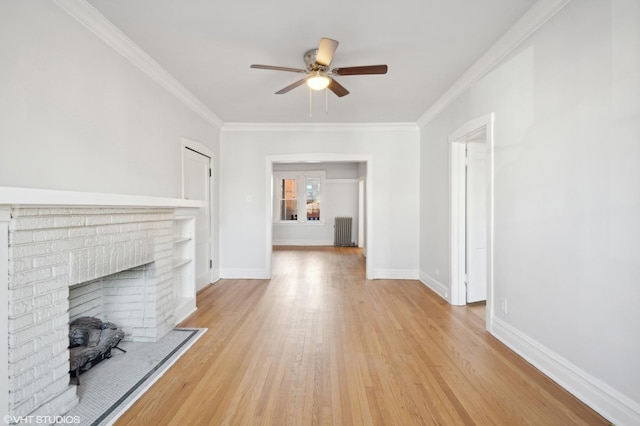 unfurnished living room with ceiling fan, radiator heating unit, a fireplace, light hardwood / wood-style floors, and ornamental molding