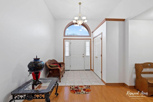 entryway with an inviting chandelier and light wood-type flooring