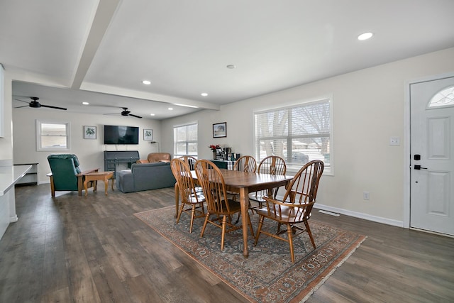 dining area with dark hardwood / wood-style flooring and beam ceiling