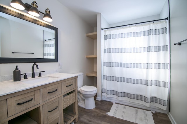 bathroom featuring hardwood / wood-style flooring, vanity, toilet, and a shower with curtain