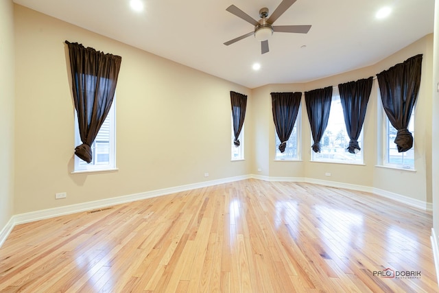 spare room featuring light hardwood / wood-style flooring and ceiling fan