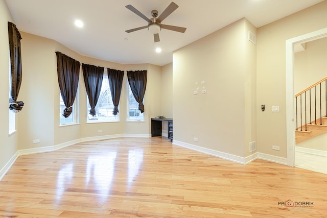 unfurnished room with ceiling fan and light hardwood / wood-style flooring