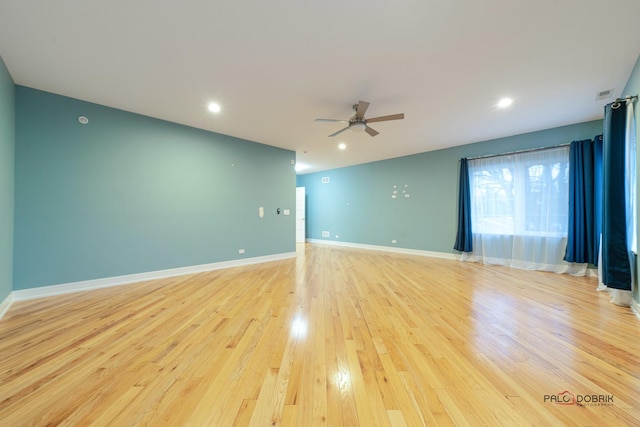 spare room with ceiling fan and light hardwood / wood-style floors