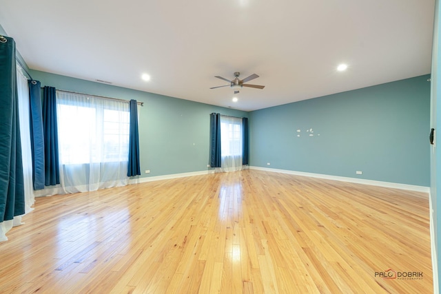 spare room with ceiling fan and light hardwood / wood-style floors