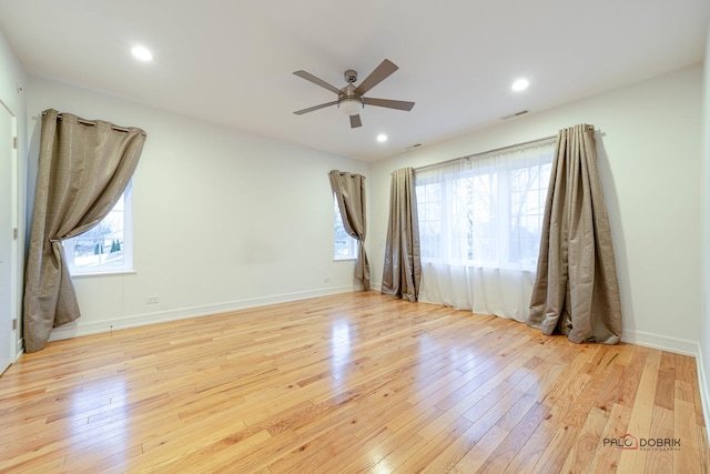 spare room featuring ceiling fan and light wood-type flooring