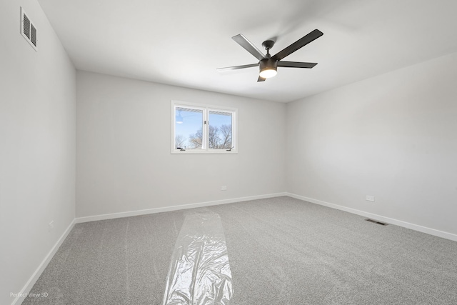 spare room featuring carpet and ceiling fan