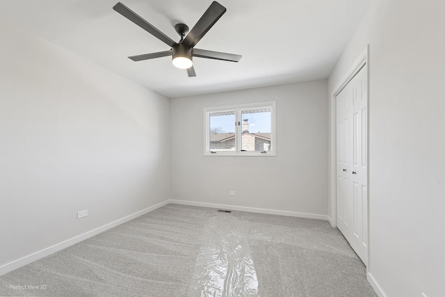 spare room with light carpet and ceiling fan