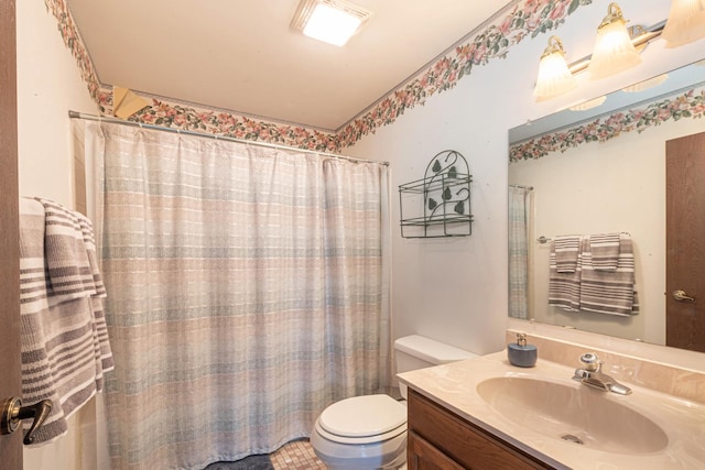 bathroom with vanity, toilet, and curtained shower