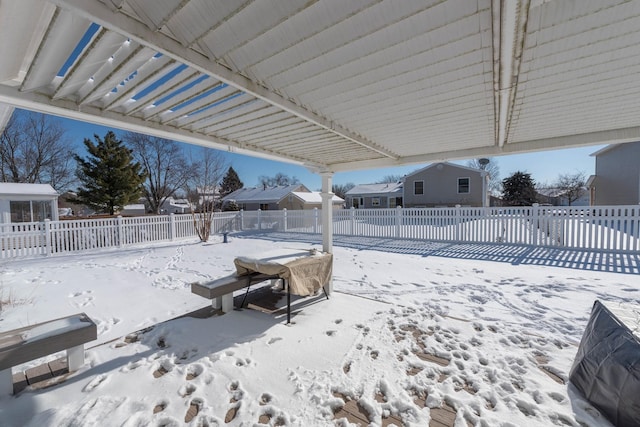 yard covered in snow with a pergola