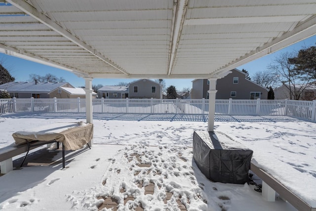 yard layered in snow with a pergola