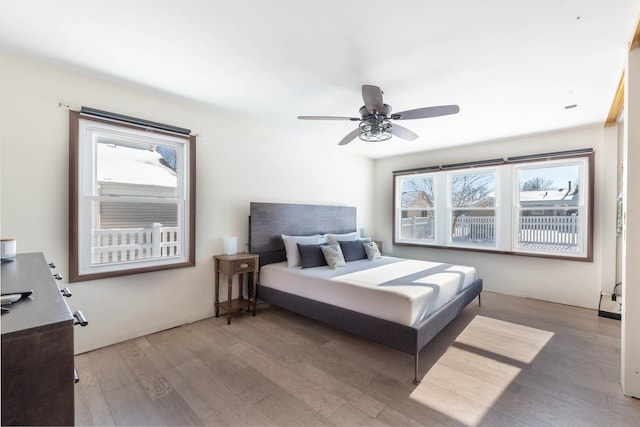 bedroom featuring hardwood / wood-style floors and ceiling fan