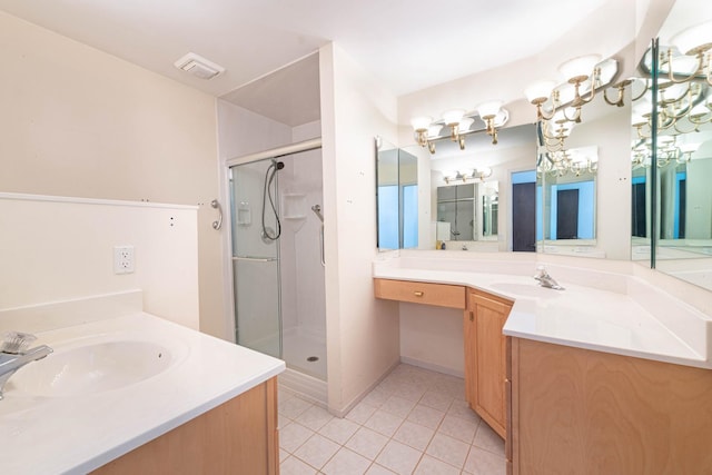 bathroom with vanity, tile patterned flooring, and a shower with door