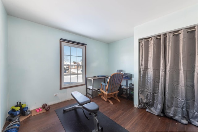 workout area with dark wood-type flooring