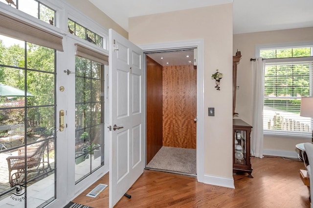 entryway featuring hardwood / wood-style flooring and french doors