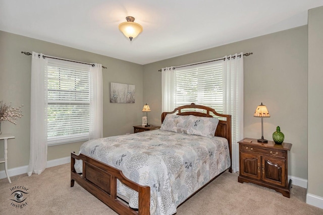 carpeted bedroom featuring multiple windows