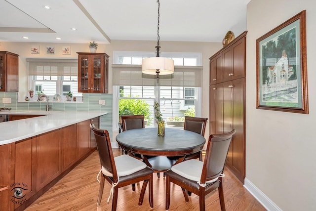 dining room featuring sink and light hardwood / wood-style floors