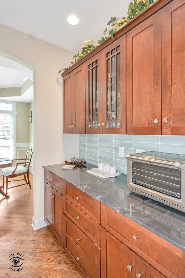 kitchen featuring tasteful backsplash and light hardwood / wood-style floors