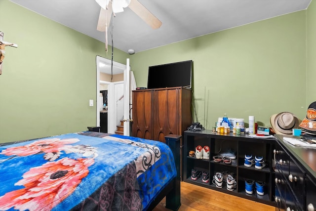 bedroom featuring hardwood / wood-style flooring and ceiling fan