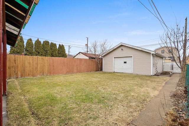 view of yard with a garage and an outbuilding