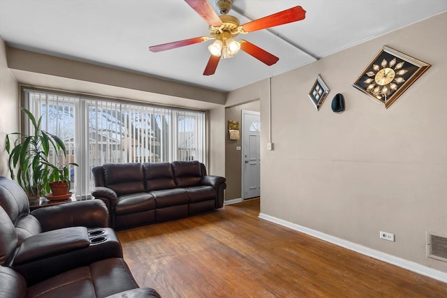 living room with hardwood / wood-style flooring and ceiling fan