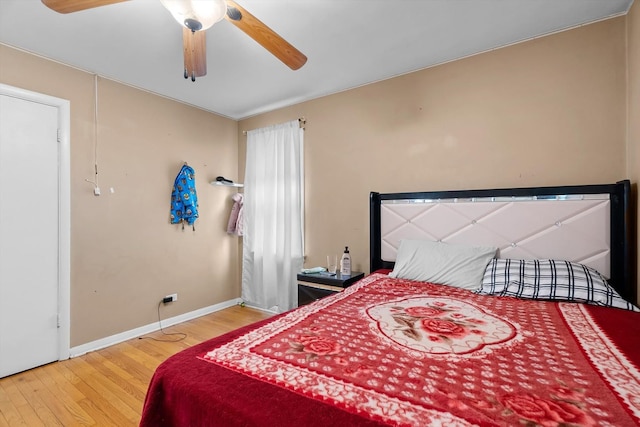 bedroom with wood-type flooring and ceiling fan