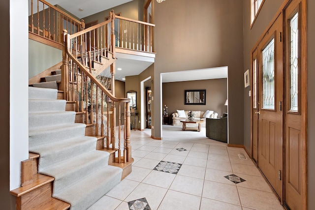 entrance foyer featuring a high ceiling and light tile patterned floors