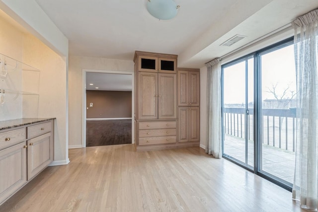 interior space with visible vents, light wood-type flooring, and baseboards