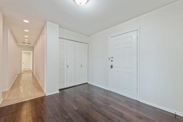 entryway with recessed lighting, baseboards, and dark wood-style flooring