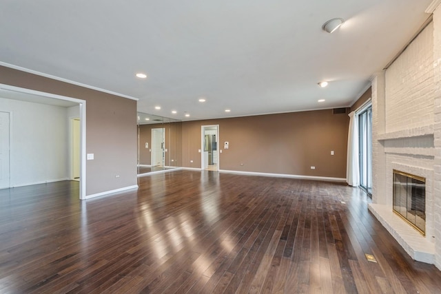 unfurnished living room featuring visible vents, baseboards, dark wood-style floors, and a fireplace