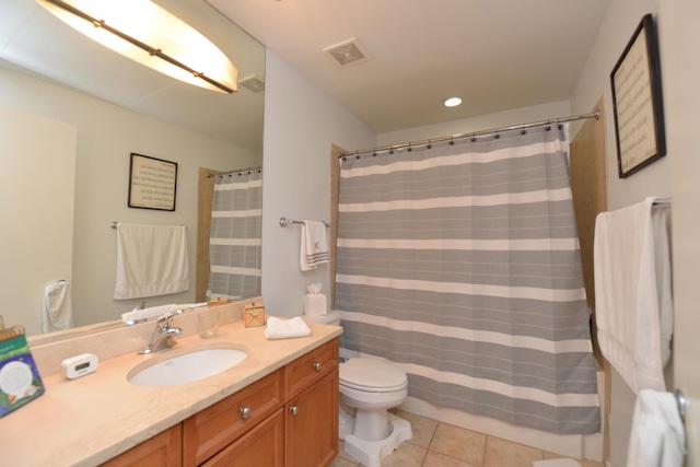 bathroom with vanity, curtained shower, tile patterned floors, and toilet