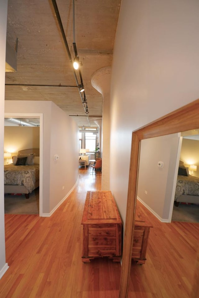 hallway with hardwood / wood-style flooring