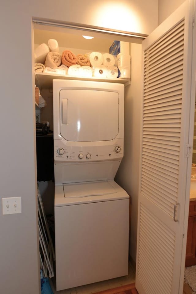 washroom with stacked washer and dryer