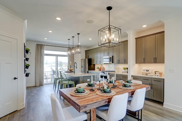 dining room featuring crown molding and light wood-type flooring