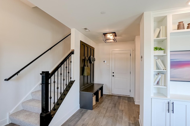 interior space featuring light wood-type flooring and built in shelves